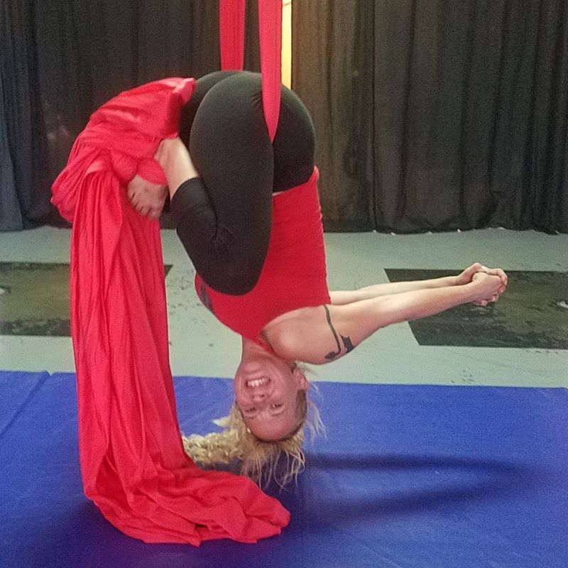 Queen Daisy Chain upside-down on silks with German body folded in half.