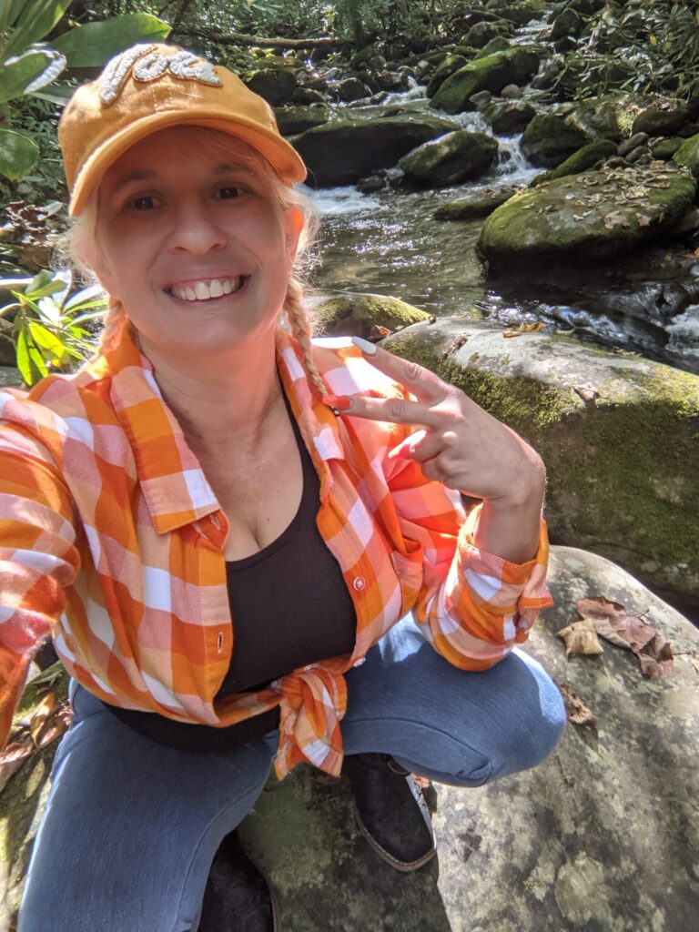 Queen Daisy Chain at the Great Smoky Mountains National Park in an orange checkered Vols shirt.