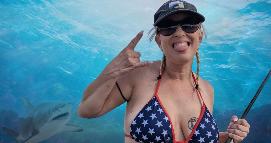 Queen Daisy Chain holding a fishing pole in an American themed bikini