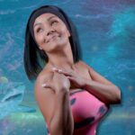 Queen Candy Kane in front of an ocean backgound with a shark.