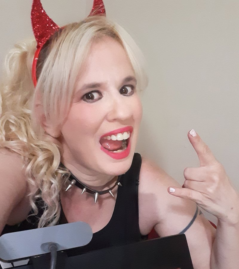 Queen Daisy Chain at her computer with devil horns